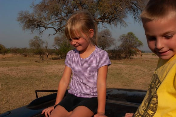 Kids, a Discovery, and giraffe in Zimbabwe