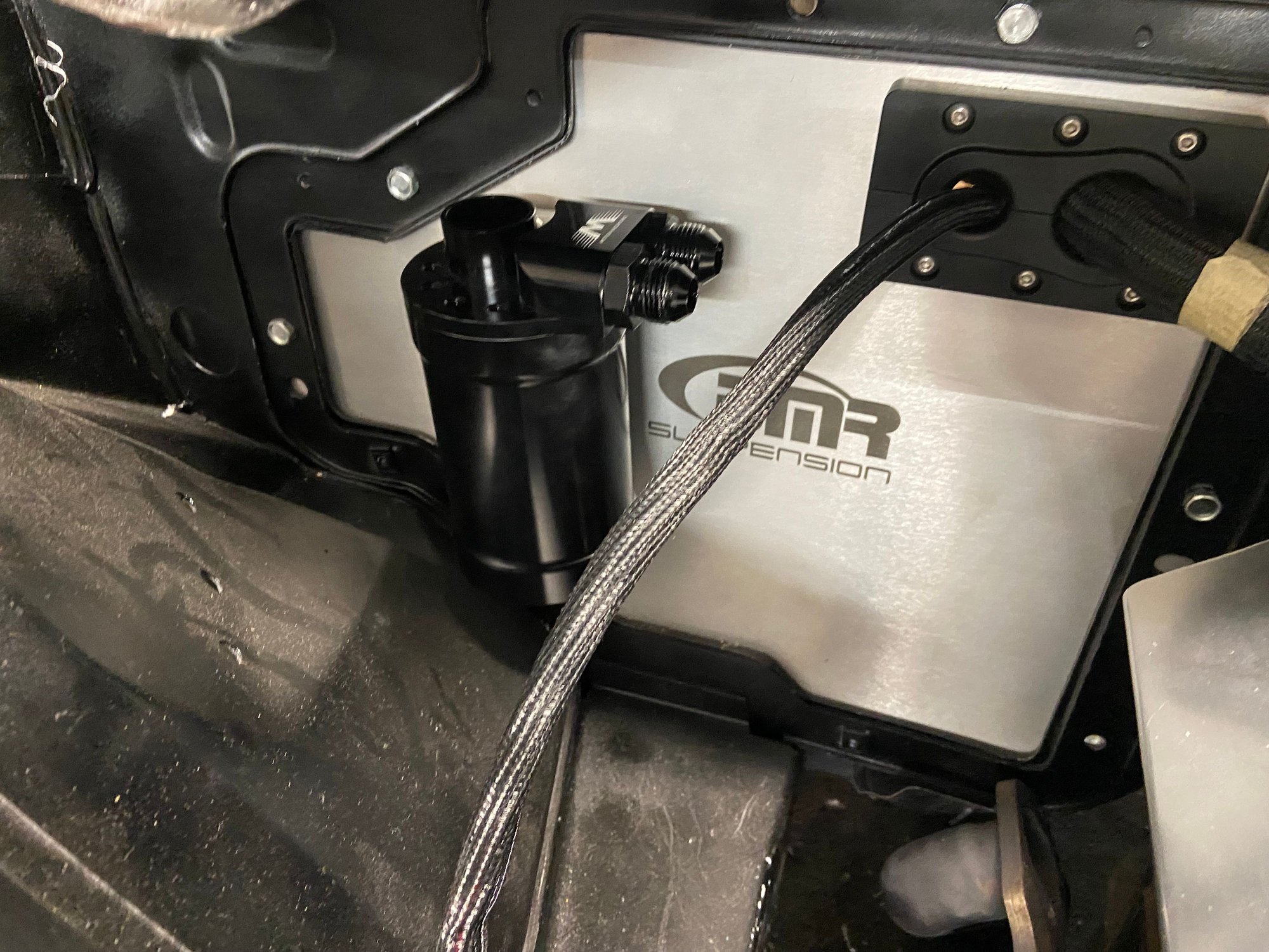Mounting the can onto the A/C delete panel for east of access and on a flat surface. Used revnuts and bolts to secure bracket.