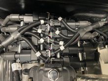 Modified a coil bracket with some scrap metal to mount my coils in the back side of the truck intake manifold. They fit under the air cleaner and was about the only place that would fit properly. Also gives it a natural look as if it has a distributor.