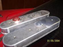 valve covers...  dusty from sitting in the garage.. i wiped down the right side of one...  just with a dry towel.  with some polish and about 15 minutes these will polish out real nice.  they take stock valve cover gaskets, new ones included with hardware of course.