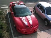 Trans Am with stripes, parked next to a Ford Ka.