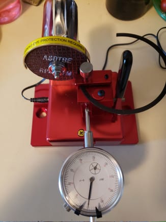 How you set the the ring up(Using a broken ring for display only). You square the end of the ring against the wheel, then tighten the rind clamp, turn the face of the dial indicatot to zero. Then you turn on the motor and then gently push the black handled lever forward while watching the dial indicator to determine how much you want removed. 
