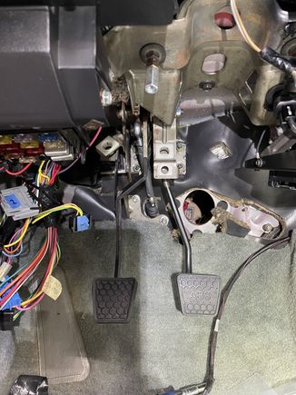 You can see the clutch rod in the center of the picture between the pedals.  It's easy to notice the angle and that it's not perpendicular to the pin on the side of the pedal.