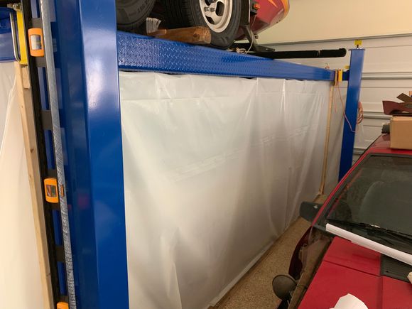 I decided to use my 4 post lift as the “frame” for the paint booth. You can see my red, donor car in this picture.
