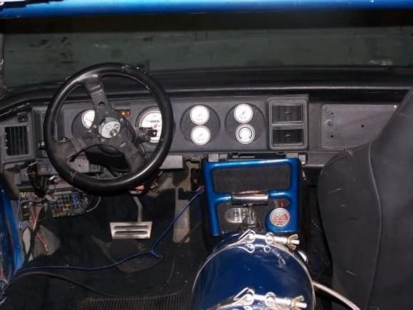 AUTO METER PROCOMP ULTRA LITE GAUGES 
(NOT THE STEERING WHEEL THAT IS BEING USED) 
CONSOLE, NITROUS BOTTLE, AND THE ROLL CAG IS COLOR MATCHED TO THE CAR