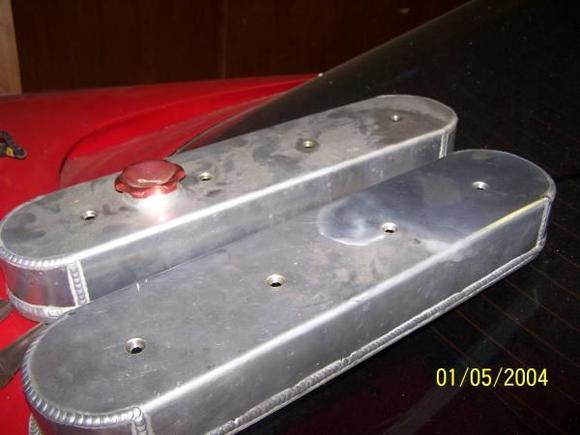 valve covers...  dusty from sitting in the garage.. i wiped down the right side of one...  just with a dry towel.  with some polish and about 15 minutes these will polish out real nice.  they take stock valve cover gaskets, new ones included with hardware of course.