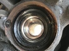View of hub and bearing from inside with axle removed. Looks like the seal is a little beat up and grease is coming out. Perhaps there’s a little dirt or something that got in there and that could be the culprit. I cleaned the abs sensor while I was there, no change.

Btw. I have noticed a barely noticeable moan/ roar when wheel turned slightly right say on an off ramp which I believe would point to the same LH bearing.  

Next move- swap out for a junkyard spindle and cross my fingers. 