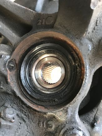View of hub and bearing from inside with axle removed. Looks like the seal is a little beat up and grease is coming out. Perhaps there’s a little dirt or something that got in there and that could be the culprit. I cleaned the abs sensor while I was there, no change.

Btw. I have noticed a barely noticeable moan/ roar when wheel turned slightly right say on an off ramp which I believe would point to the same LH bearing.  

Next move- swap out for a junkyard spindle and cross my fingers. 