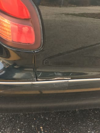 Bought the car 3 years ago with this damage. Looks like someone hit it here. It is dented in. My plan is to fill this in and primer and paint it. 