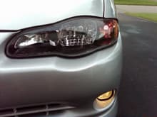 LED turn signal Black headlight with HID and yellow fog lights.
