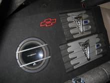 Rear seat delete. This is not a bad set up. Amplifiers were installed and then surrounding area was form fitted to provide a recessed effect for the amplifiers. The Massive Audio Subwoofer projects into the cabin and is installed in such a way that it is easily removable from the rear.