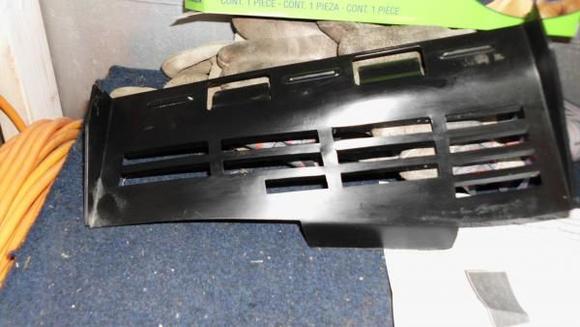 Plastic Peice that attaches on to cabin Filter Under grill