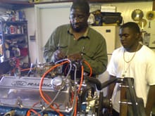 Simuel Johnson assembling the engine, My son Keenen watching closely!!