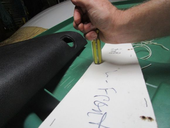 Smoothing hole rims with screwdriver handle end