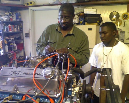 Simuel Johnson assembling the engine, My son Keenen watching closely!!