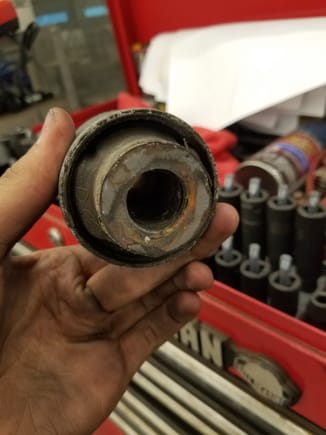 Old compression arm bushing driver side (came off frame with a little convincing)