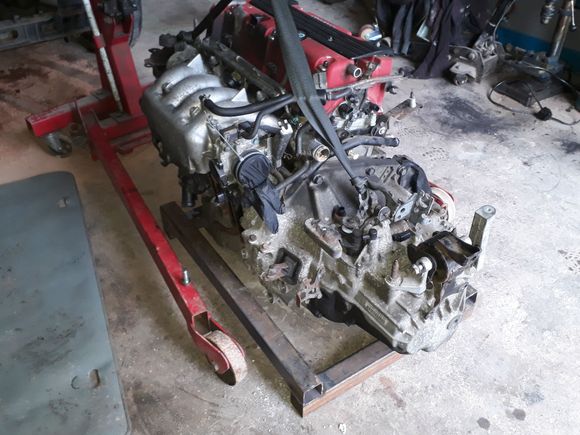 Ive made a basic frame with castor wheels.. also started to make an adjustable front gearbox mount using a jack..(May aswel use scrap parts) the driveshafts won't be a problem. I know of a motorsport company who makes shafts. I will have to cut both ends, make a sleeve & weld them, then the will be matched & made... im currently spending about an hour a day on it during lunch breaks at work so its not going to be a fast project.. 