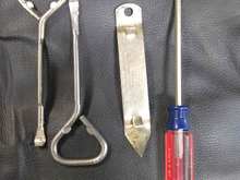 Two paint can opener tools, old fashioned can opener and a small screwdriver