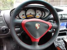 The red on the steering wheel somewhat matches the needles on the gauges