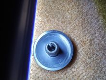 Photograph of the underside of the threaded button securing the driver's side mats to the carpets to your cars existing threaded stud, driver's side. The threaded buttons are provided by Lloyd's with your purchase.