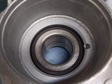 Here is the bearing inside the wheel carrier. Do I put a plate on the metal inner race and just press it onto the hub? 