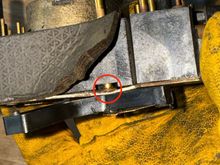 Circled in red is where the c-clip that retains the horn contact is found, the rubber cover must be peeled back to reveal this. 
