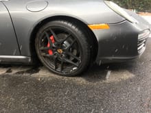 Damaged wheel, tire and bumper cover.