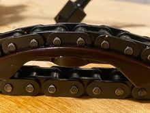 Old pad with chain to show how much it has eaten into the pad