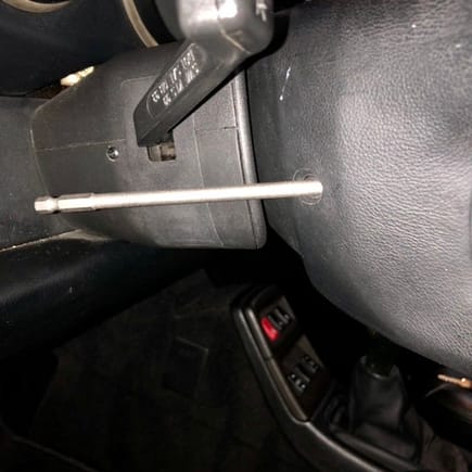 The torx tool should be angled forward toward the airbag to loosen the screws on each side.  It does not go in horizontally.