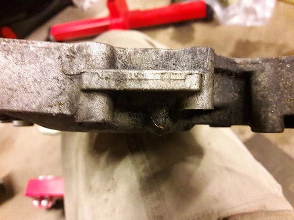 The housing that came off the car has one that's a little shorter. It needs to be, so the timing belt tensioner can clear it and bolt down to the block properly.