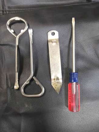 Two paint can opener tools, old fashioned can opener and a small screwdriver