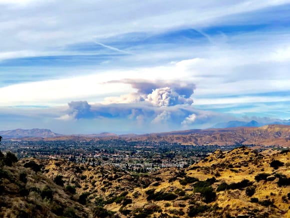 The huge Thompson Fire still going strong after a full week of burning through Ventura and Santa Barbara counties in California. 
This is an iPhone image taken from the top of the Santa Susanna Pass in the NW corner of the San Fernando Valley overlooking Simi Valley. Looking west, this fire is over 50 miles away! 