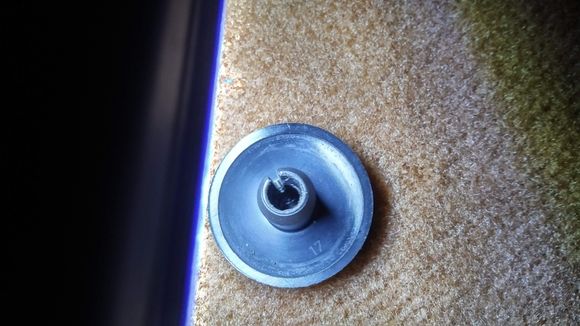 Photograph of the underside of the threaded button securing the driver's side mats to the carpets to your cars existing threaded stud, driver's side. The threaded buttons are provided by Lloyd's with your purchase.