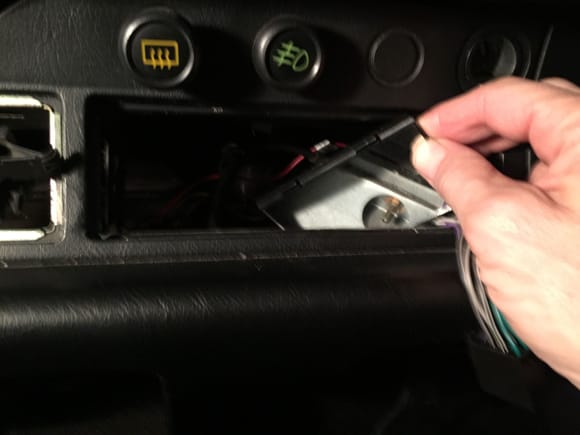 I used a small mirror to spot the two screws on the inside of the dash.