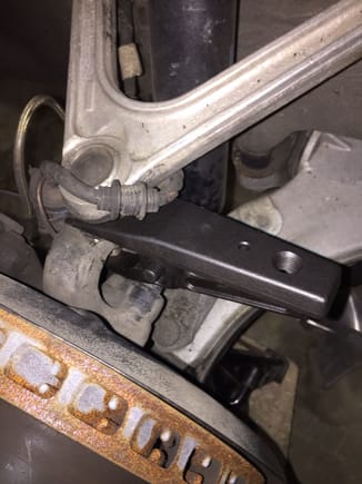 First taped the joint separator fork into position under the old torn boot. Then attached the lever arm using pin. Made sure lever tip was under the ball joint bolt. Then inserted the bolt into the threaded hole in the separator and turned it slowly with a Gear wrench.