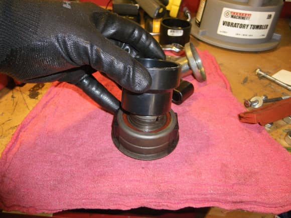 Using a PVC pipe as a tool to press the bearing out of the throw out bearing body