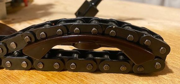 Old pad with chain to show how much it has eaten into the pad