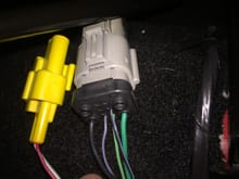 OEM elect plug drivers side. The green and black wires power the lumbar and power seats. I cut these since the new seats are not power. they are the green and black wires on the left and right. you want the three wire in the center for the seatbelt and track sensor. the yellow plug is not used on my 2005.