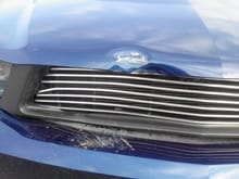 damaged hood and grill front view