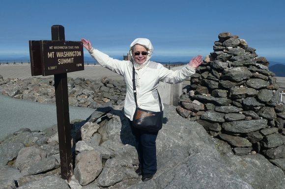 My wife was cold and fighting the wind at the summit.