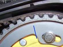 The small engraved line between the two cogs is the front camshaft timing mark. It is located just above, and in line with the blue line on the photo.