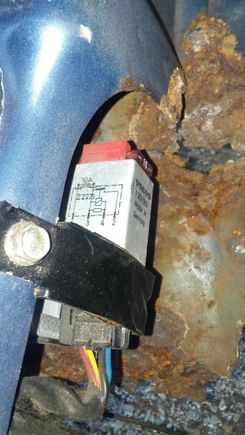Located under the passenger seat... above the hole in the floorboard.