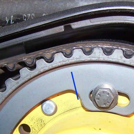 The small engraved line between the two cogs is the front camshaft timing mark. It is located just above, and in line with the blue line on the photo.
