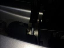 The drains are at the rear of the hinge mechanism.Raise it to access.