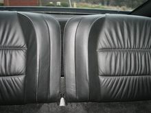 Subwoofer enclosure hidden behind rear seats.