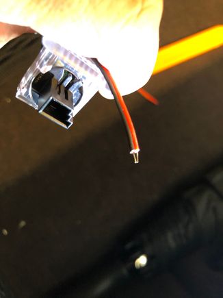 Black connector on stock LED light, next to new LED strip wire I need to connect
