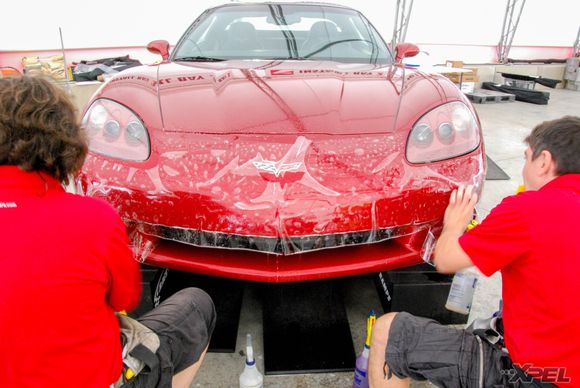 The guys from Clear Auto Bra are installing XPEL ULTIMATE on the front bumper