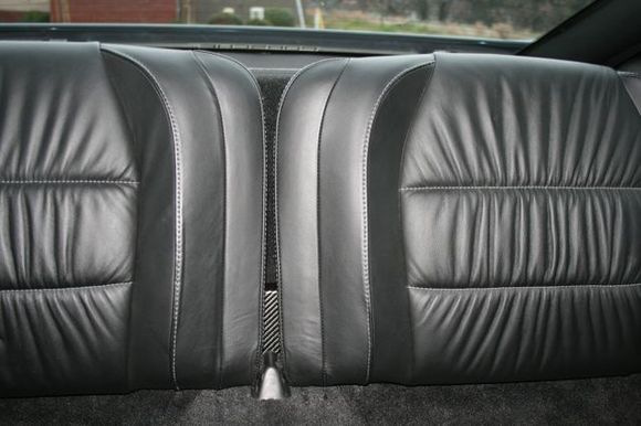 Subwoofer enclosure hidden behind rear seats.