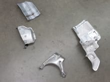 All of the brackets and heat shields that were removed. Top Left: passenger CV shaft cover, Middle Left: Driveshaft heat shield, Bottom Middle: Catalytic Converter bracket holder (You don't need this anymore, can be completely removed with new DP), Right: Power Steering pump heat shield. Removing will make things 100% easier to remove stock.