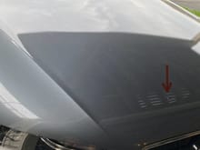 arrow points as the small dent from highway chips